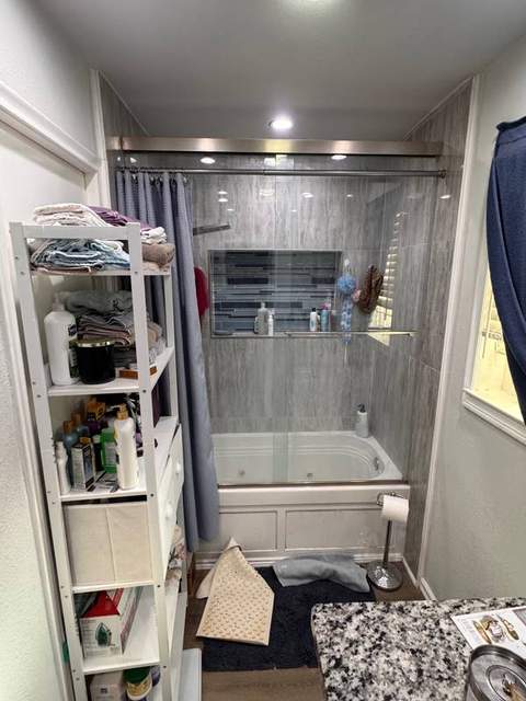 Primary bathroom before remodel with the existing tub and shower.