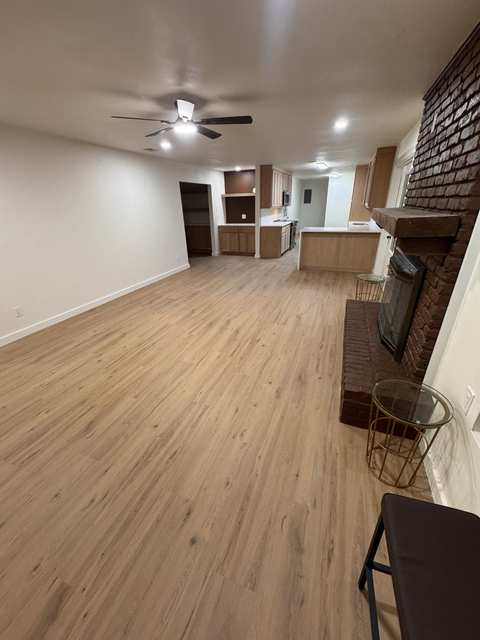 Finished living space connected to the completed kitchen after the whole-home renovation.